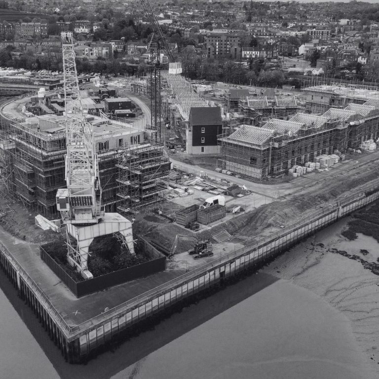 Infrastructure Inspections Construction site featuring industrial machinery and developing buildings beside the River Medway in Rochester, Kent, England.